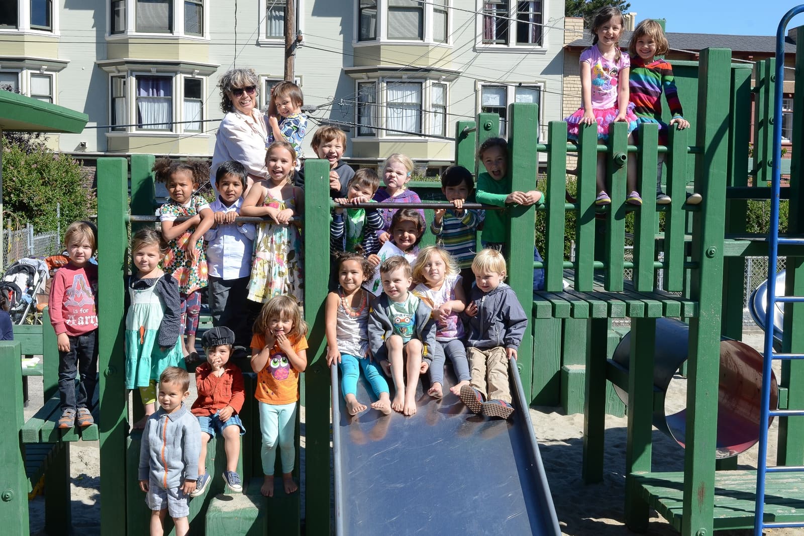 The whole school, children and teachers, gathered on and around the play structure for a group photo